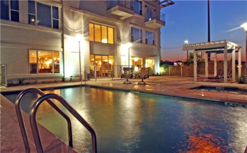 a swimming pool in front of a building at Casulo Hotel in Austin