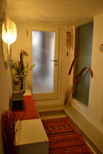 a hallway with a door and a red rug at B&B Cappuccini in Schio