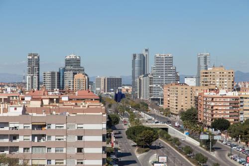 a city with tall buildings and a street with cars at Pio XII Apartments Valencia in Valencia