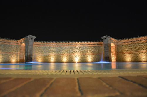 a white building with a fountain in the middle at La Piana Dell'erika in Aprilia