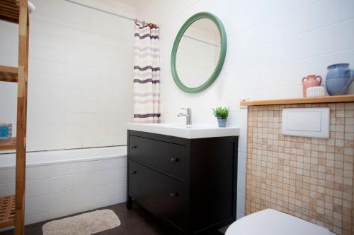 a bathroom with a sink and a mirror at Aska Apartment in Reykjavík