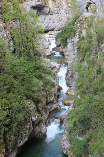 a river running through a rocky canyon with waterfalls at Le Chalet du Berger in Briançonnet