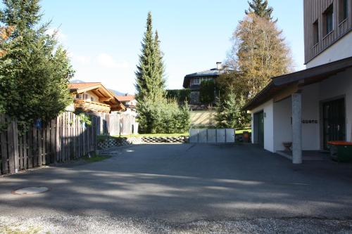 a driveway in front of a house with a fence at Ferienwohnung Gabriele in Brixen im Thale