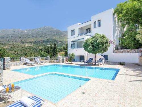 a villa with a swimming pool and a building at Modish Villa in Lefkogia Crete with Swimming Pool in Lefkogeia