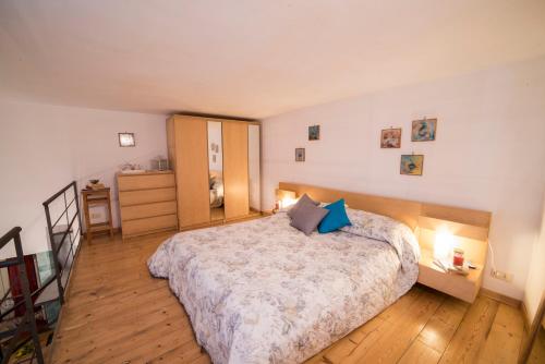 a bedroom with a large bed with blue pillows at La Valle Delle Najadi in Vietri sul Mare