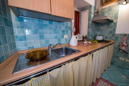 a kitchen counter with a sink and a stove at La Valle Delle Najadi in Vietri sul Mare