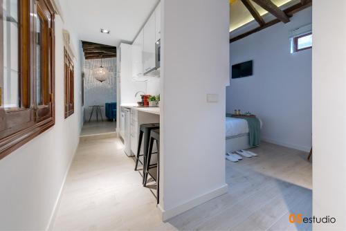 a kitchen with white walls and a table in a room at Petrus Apartment by Toledo AP in Toledo
