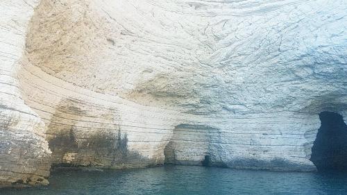 a view of a rock cliff with the water at Diomede Rooms - Manfredi Homes&Villas in Manfredonia