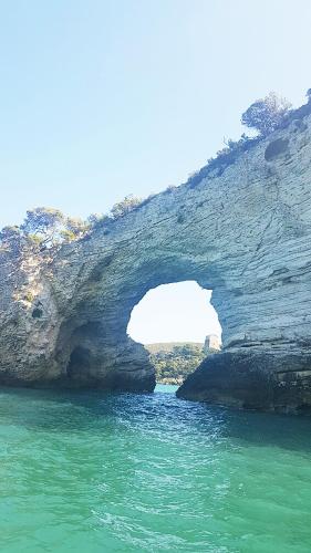 a large rock formation in the water next to the ocean at Diomede Rooms - Manfredi Homes&Villas in Manfredonia