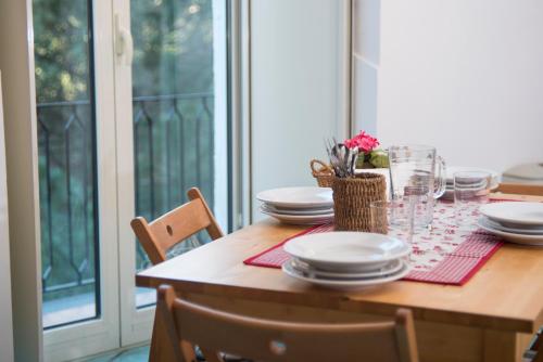 a dining room table with plates and glasses on it at La Valle Delle Najadi in Vietri sul Mare