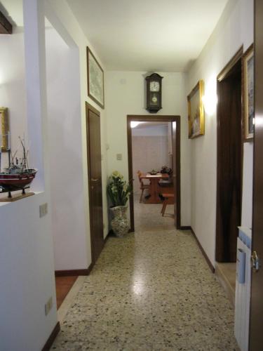 a hallway with a clock on the wall and a table at Ca' Malatin in Venice