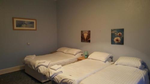 a room with two beds and two pictures on the wall at Station Hotel in Hucknall