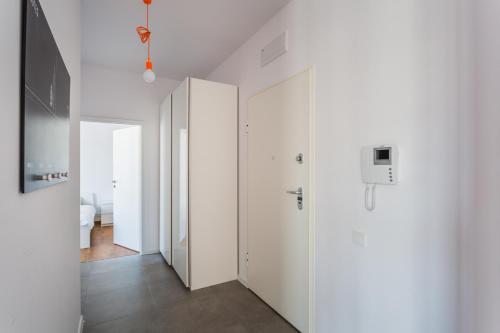 a room with a white wall and a blue door at Executive Suites Mokotów in Warsaw