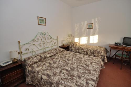 Postel nebo postele na pokoji v ubytování Hotel Pineta Mare