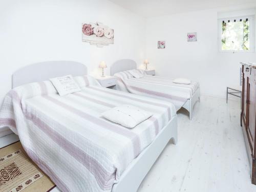 two beds in a room with white walls at Family Stay in Scenic Cazals in Cazals