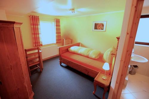 a small bedroom with a bed and a sink at Gelber Löwe B&B Nichtraucherhotel in Schwabach