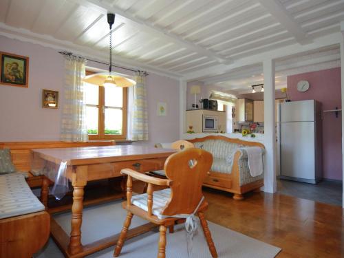 a kitchen with a wooden table and a refrigerator at Apartment with private terrace in Prunn in Riedenburg