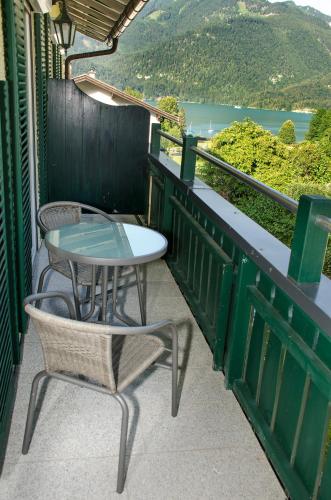 a table and chairs on a balcony with a view at Haus - Salzkammergut in Sankt Gilgen