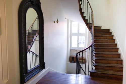 a mirror in a hallway with a stairway at Hostellerie du Coq d'Or in Jonzac