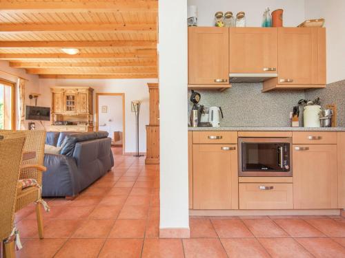 a kitchen and living room with a couch at Splendida villa isolata con piscina Biot in Le Biot