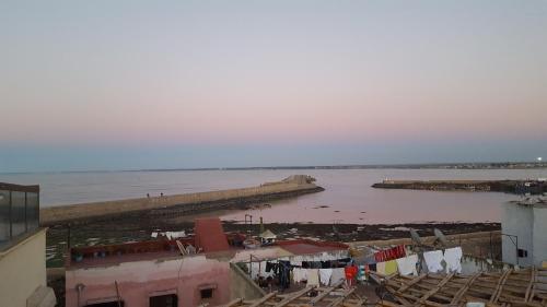 a view of a body of water with clothes hanging on a line at Art Riad Au Bord De La Mer in El Jadida