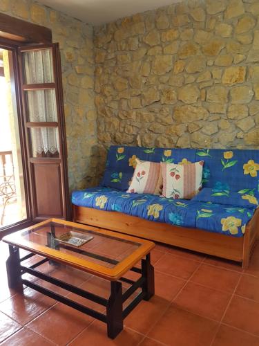 a living room with a blue couch and a coffee table at El Pedroso in Santillana del Mar