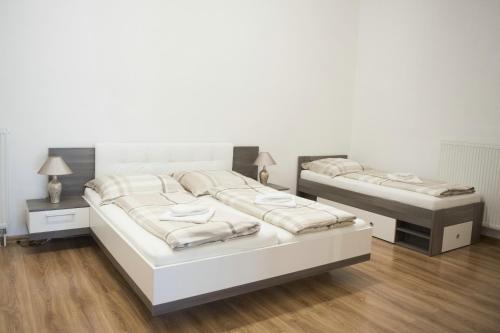 A bed or beds in a room at Olla apartmány