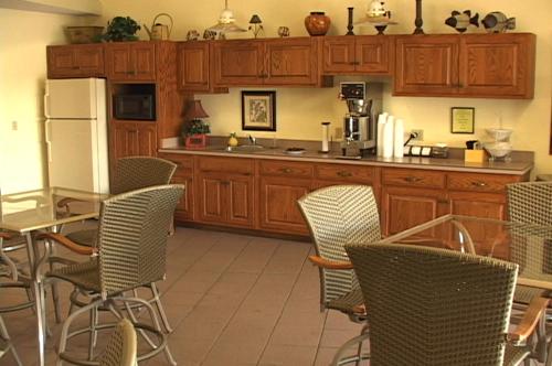 a kitchen with wooden cabinets and a table and chairs at Pine View Resort in Monticello