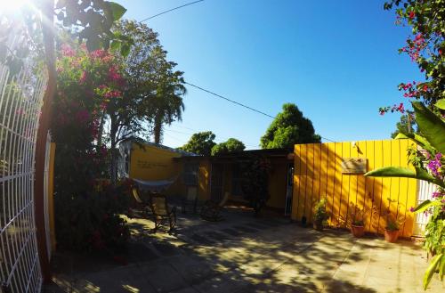 a backyard with a yellow fence and a yellow fence at Casa Lucia in Managua