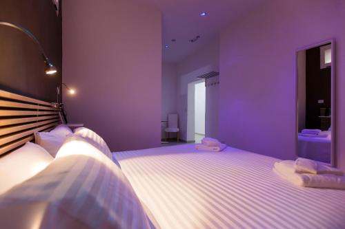 a bedroom with purple walls and a large bed at B&B Piazza Duomo in Cerignola
