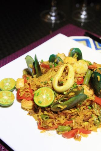 a white plate of food with rice and vegetables at Star View Boutique Resort in Dumaguete