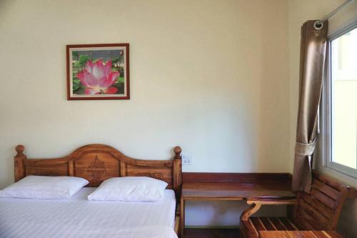 a bedroom with two beds and a picture on the wall at Anyamanee Resort Trat in Trat