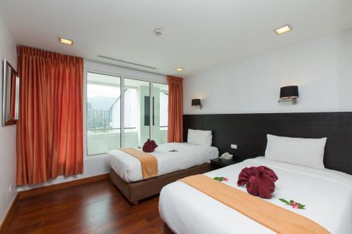 Ένα ή περισσότερα κρεβάτια σε δωμάτιο στο The Palms, Kamala Beach - SHA Extra Plus