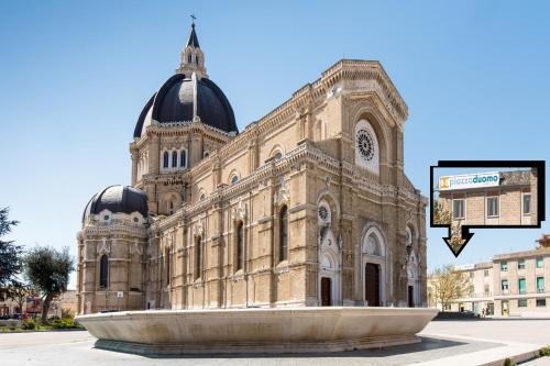 a large building with a fountain in front of it at B&B Piazza Duomo in Cerignola