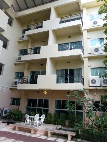 an apartment building with two chairs in front of it at C.A.P Mansion in Phuket Town