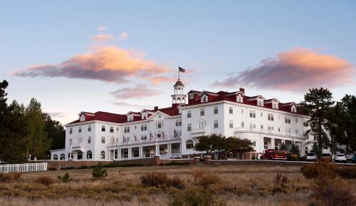 a large white building with a flag on top of it at The Stanley Hotel in Estes Park