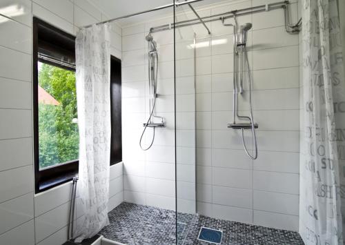 a bathroom with a shower with a glass door at Hotel & Hostel 10 in Gothenburg