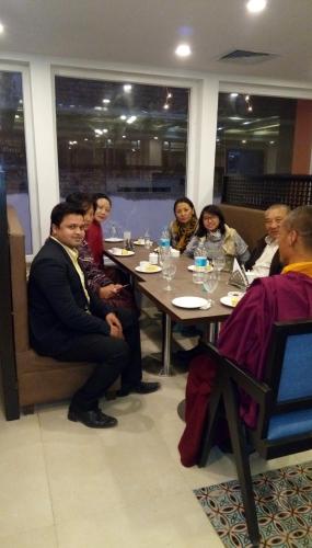 a group of people sitting around a table at Maya Heritage in Bodh Gaya