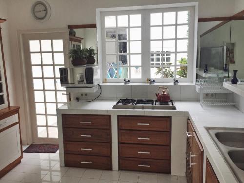 a kitchen with a sink and a stove at Yogyakarta Tropicana Villa in Yogyakarta