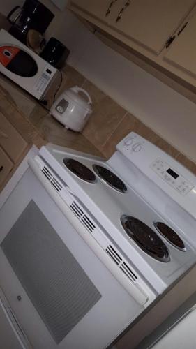 a white stove top oven in a kitchen at Beautiful 2 bedroom 1 bath in Tamuning