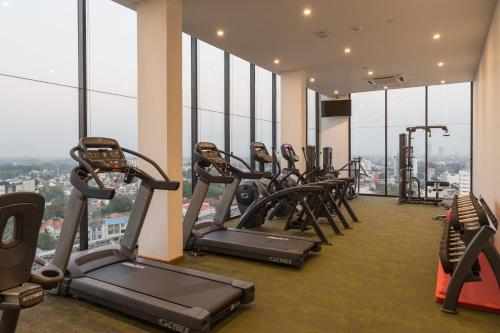 a gym with cardio equipment in a building with windows at Jetwing Colombo Seven in Colombo