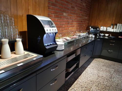 a kitchen with a large appliance on a counter at RastPunkt Laxå in Laxå
