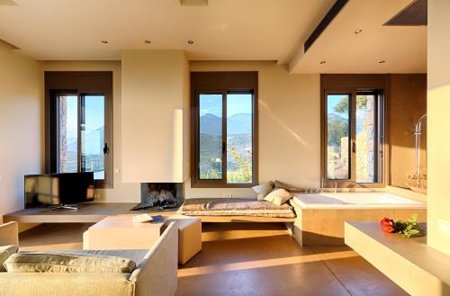 a living room with a couch and a fireplace at Euphoria Suites in Avía