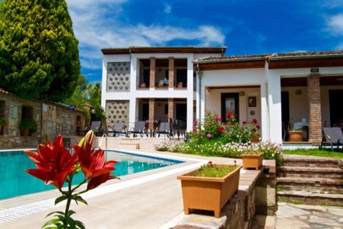 a house with a swimming pool and a house at Akay Hotel in Selcuk
