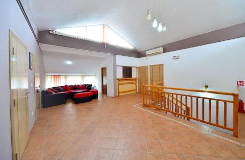 a living room with a couch and a skylight at Plitvicka Vrela in Grabovac