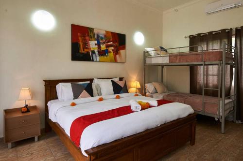 a bedroom with a bed and a bunk bed at Villa Jackson in Tejakula