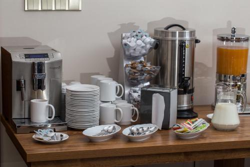 a counter with cups and bowls of food and a blender at Penzion Reichova vila in Valašské Meziříčí