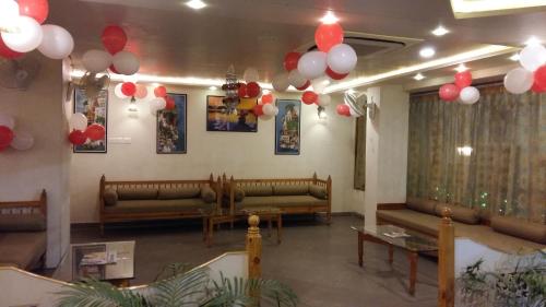 a waiting room with couches and balloons on the ceiling at Hotel Banaras Haveli in Varanasi