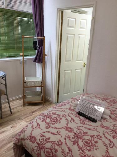 a room with a bed with a laptop on it at The Danescourt in Blackpool