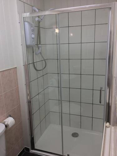 a shower with a glass door in a bathroom at The Danescourt in Blackpool